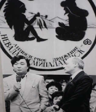 Kazakh poet Olzhas Suleimenov speaking in front of a label of the ‘Nevada-Semipalatinsk’ anti-nuclear movement.